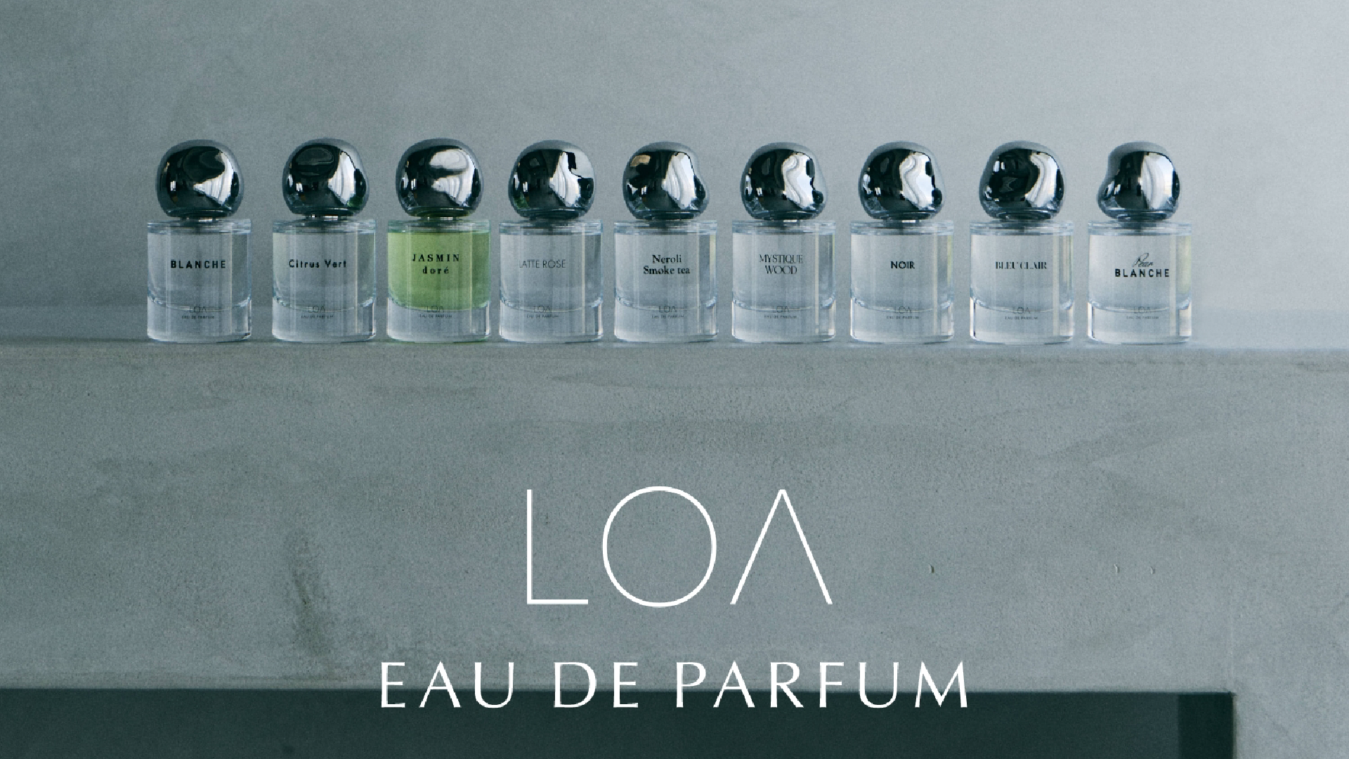LOA EAU DE PARFUMの商品がコンクリートの棚の上に横並びに置かれている